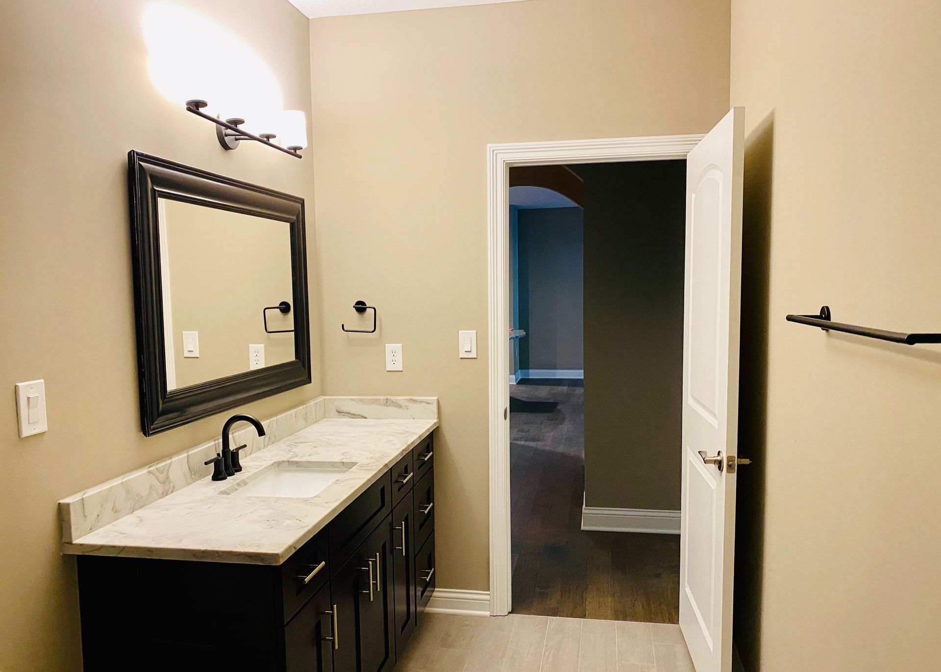 A bathroom with two sinks and a mirror.