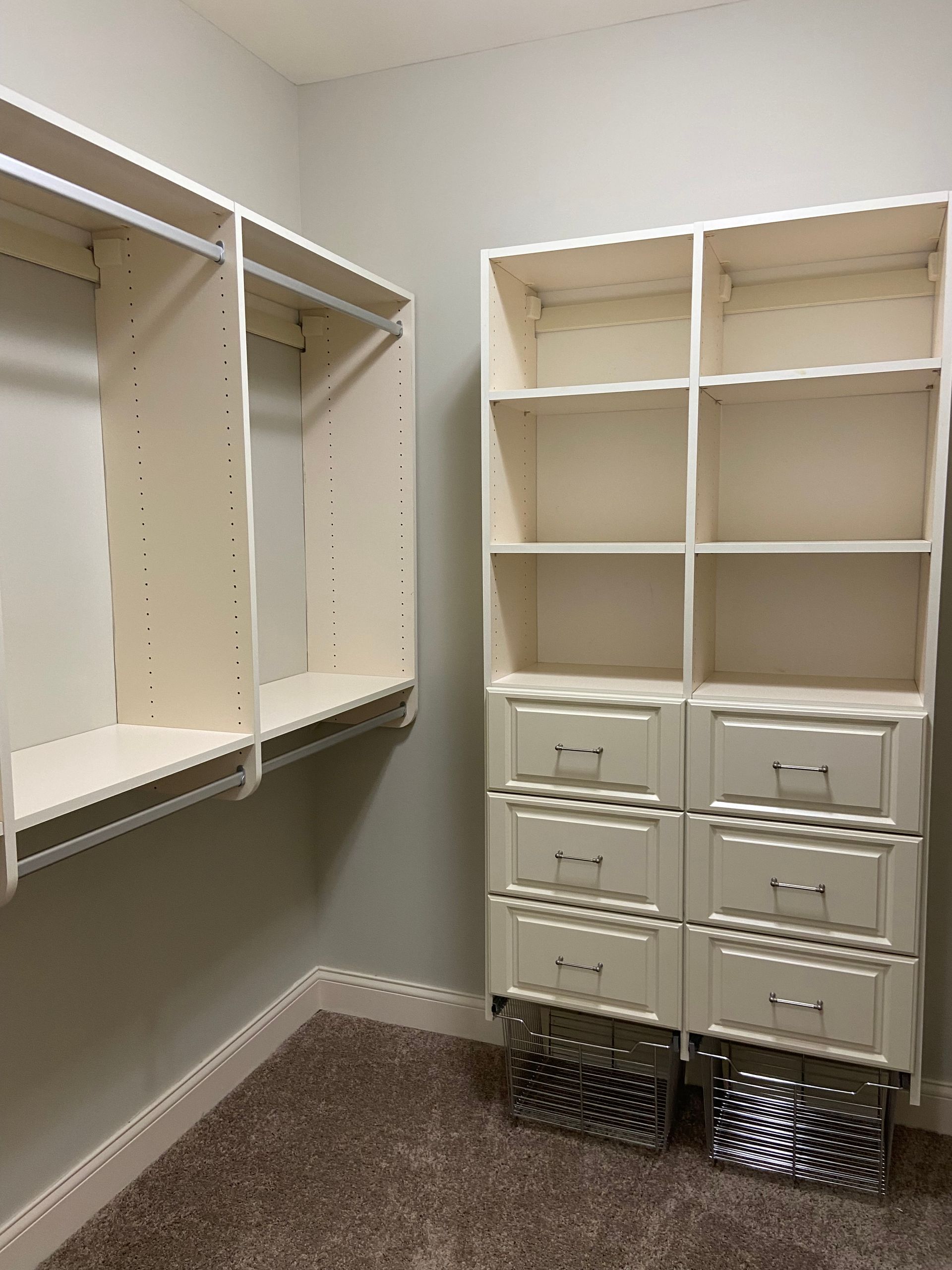 A walk in closet with lots of shelves and drawers.