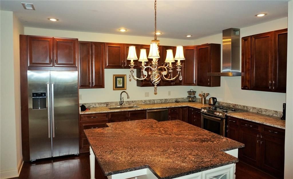 A kitchen with stainless steel appliances and granite counter tops