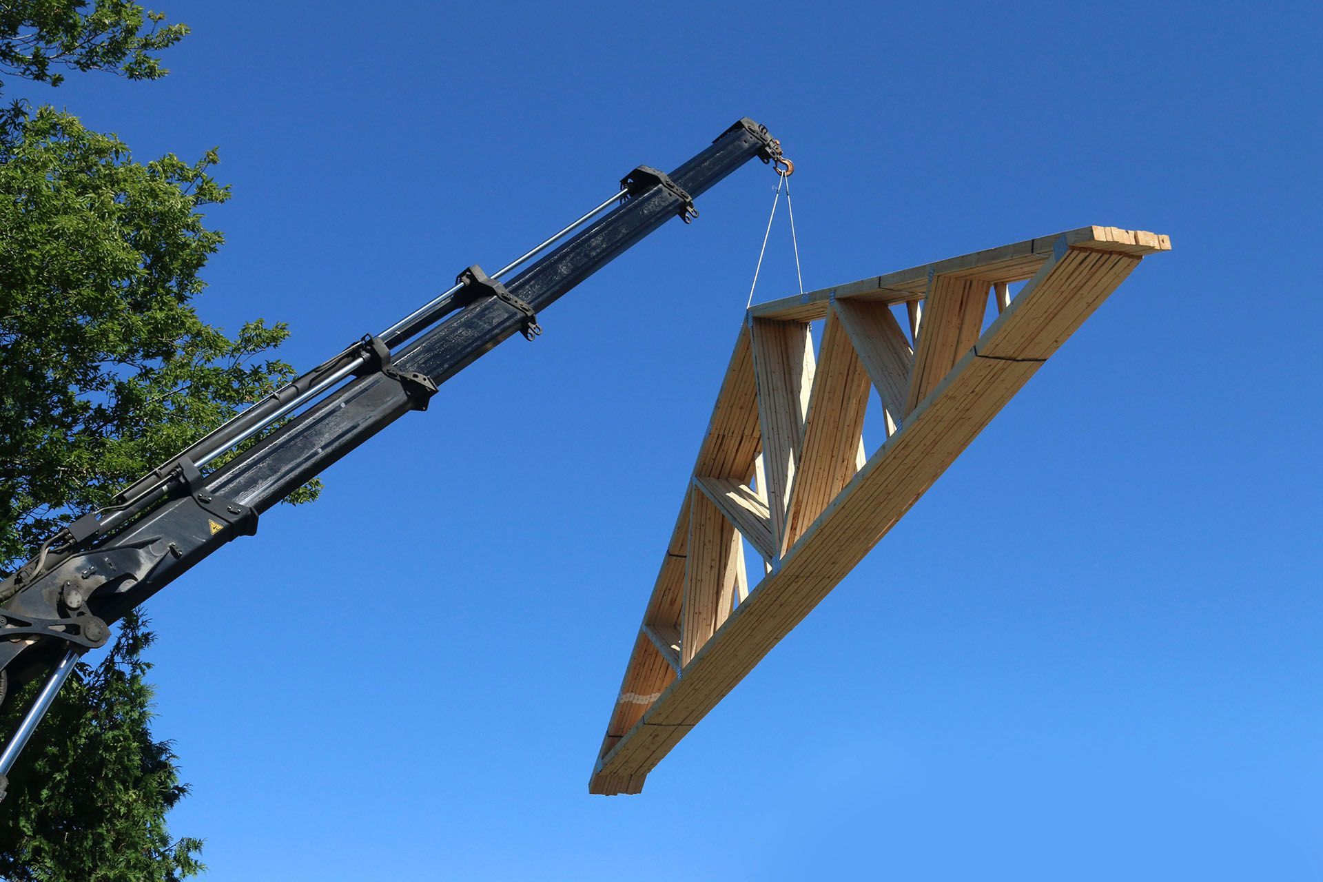 crane lifting a roof trusses