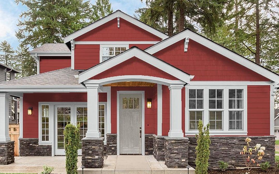 A lovely red house with white trim having newly been painted.