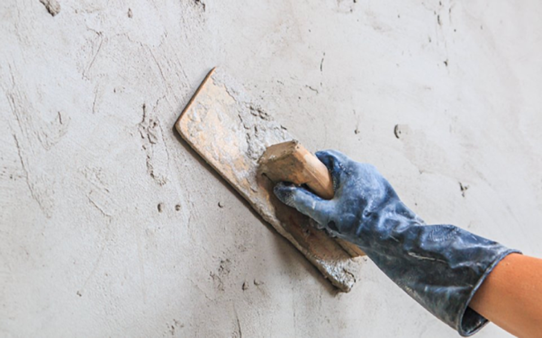 Some prep work being done on a stucco wall.