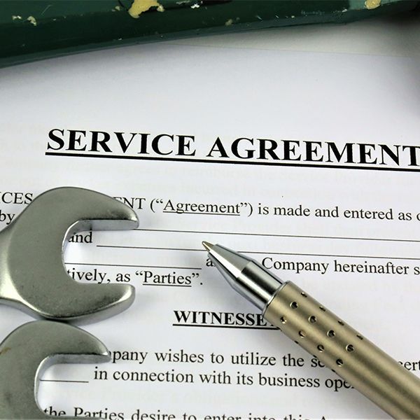 A service agreement with a wrench and pen on it