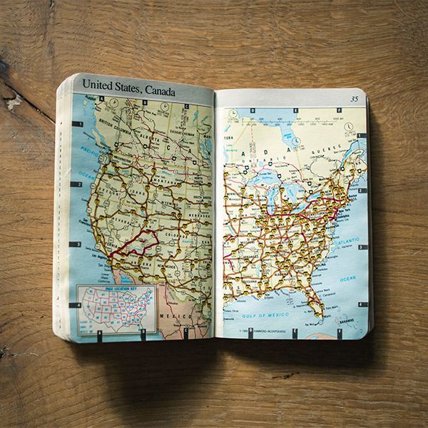 A book is open to a map of the united states