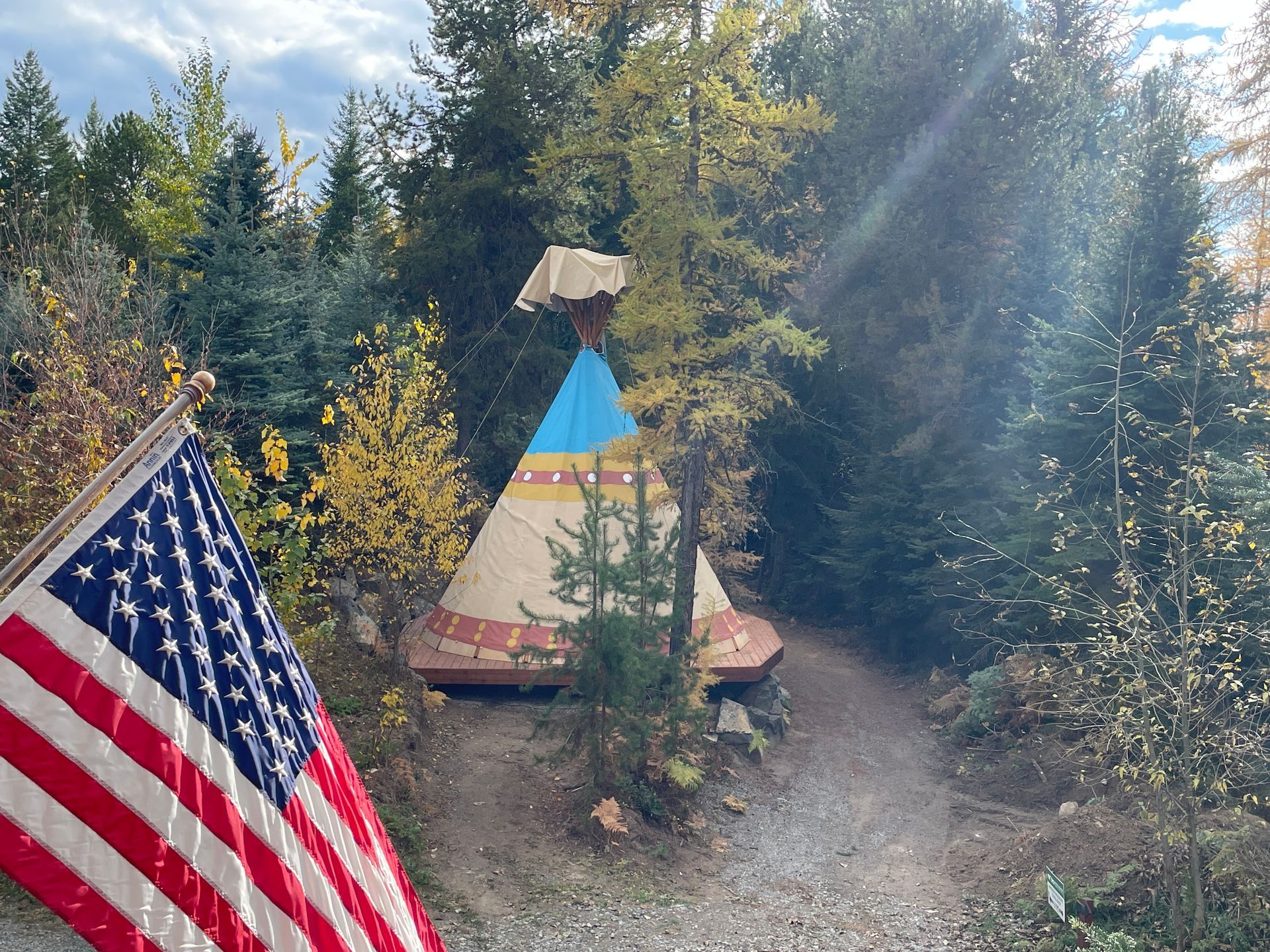 Exterior of glamping tipi on wood deck platform