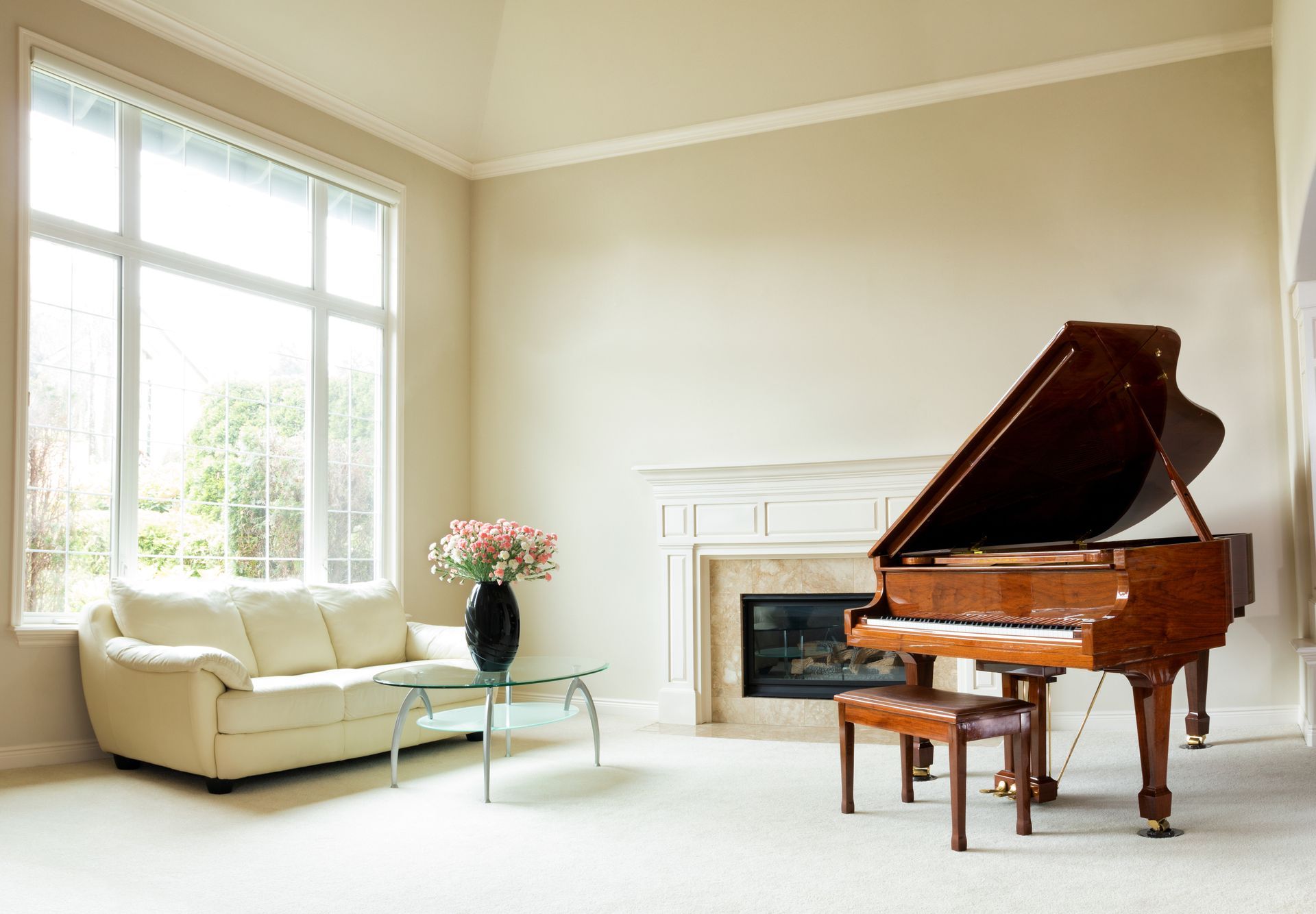 A living room with a piano and a fireplace