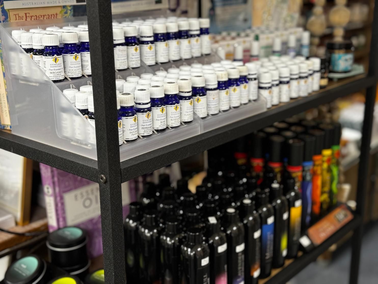 A Shelf Filled With Lots Of Bottles Of Essential Oils — Beach Time Trading Co In Yeppoon, QLD