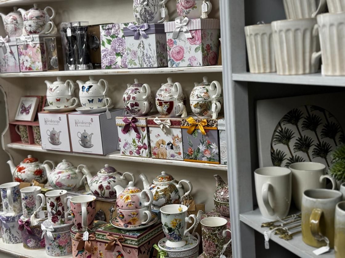 A Shelf Filled With Lots Of Teapots, Cups, And Boxes — Beach Time Trading Co In Yeppoon, QLD