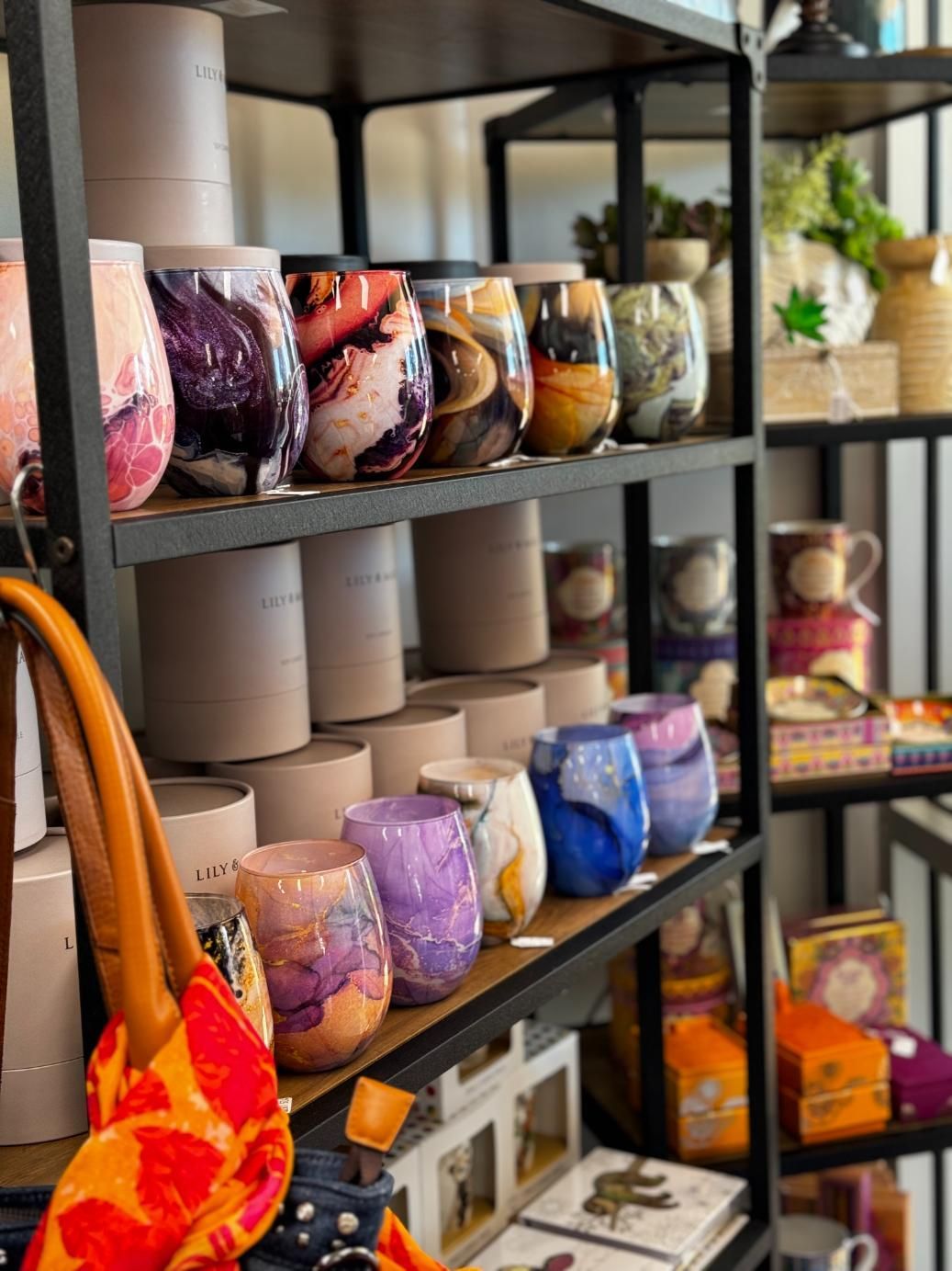 A Shelf Filled With Lots Of Candles And A Purse — Beach Time Trading Co In Yeppoon, QLD