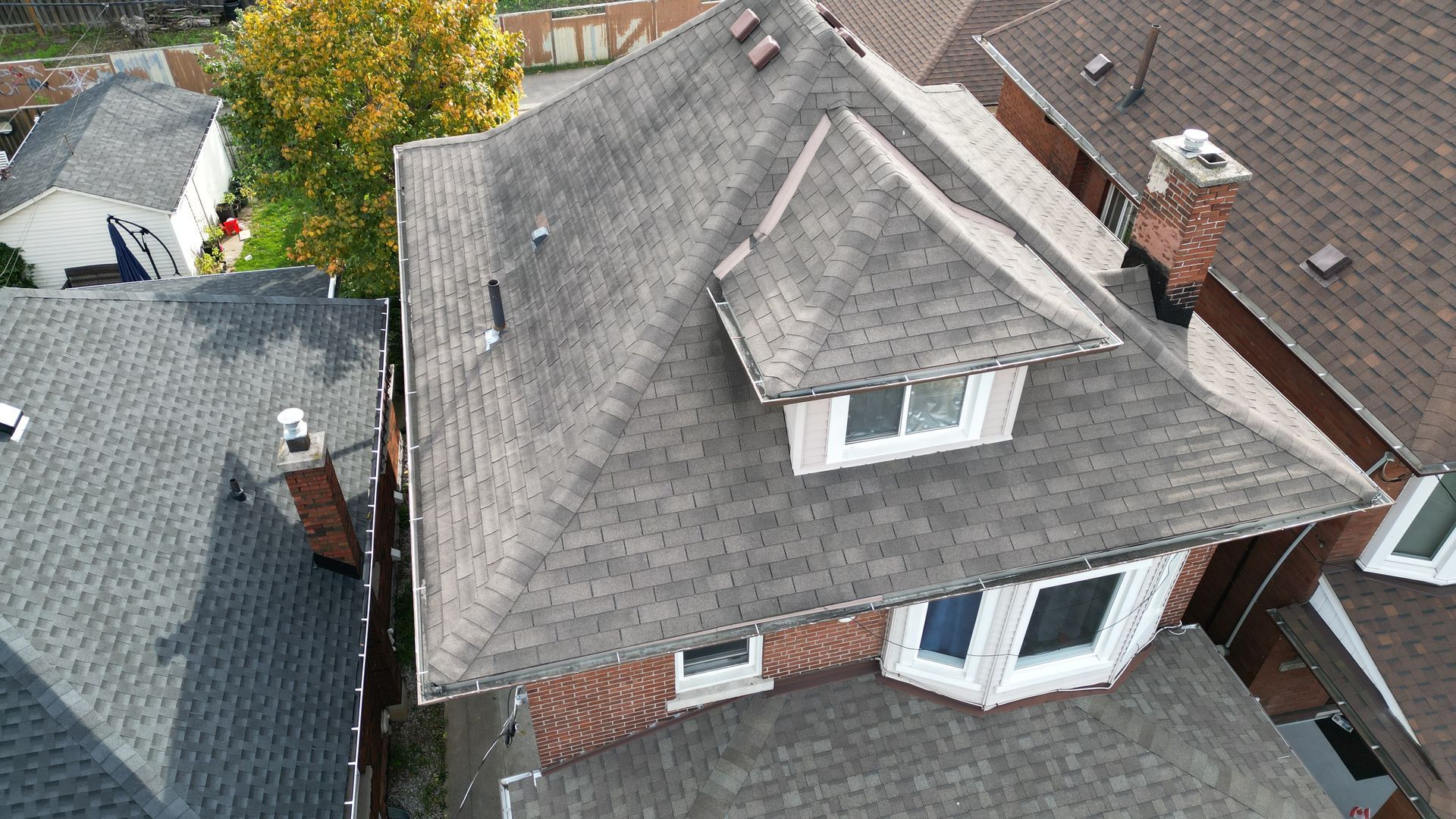 An aerial view of a house with a gray roof
