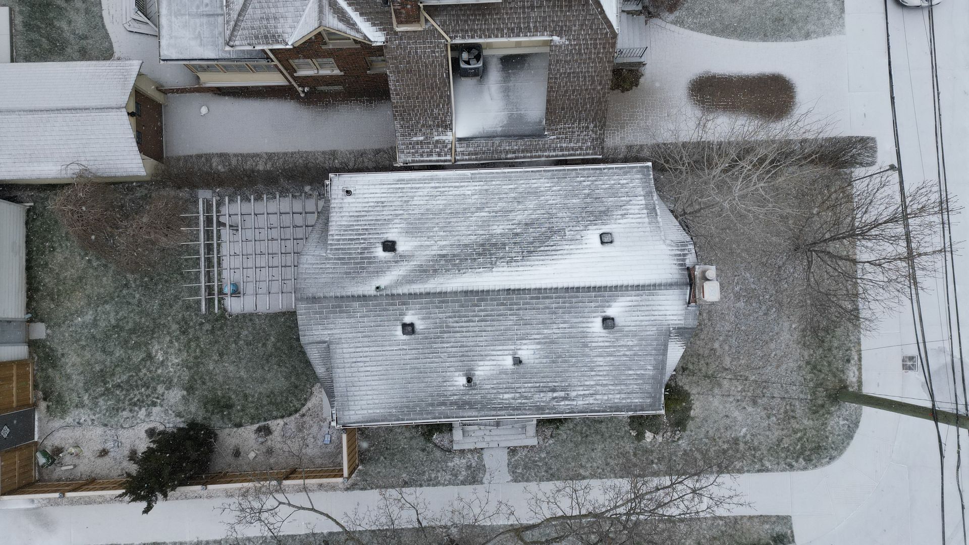 An aerial view of a house covered in snow.