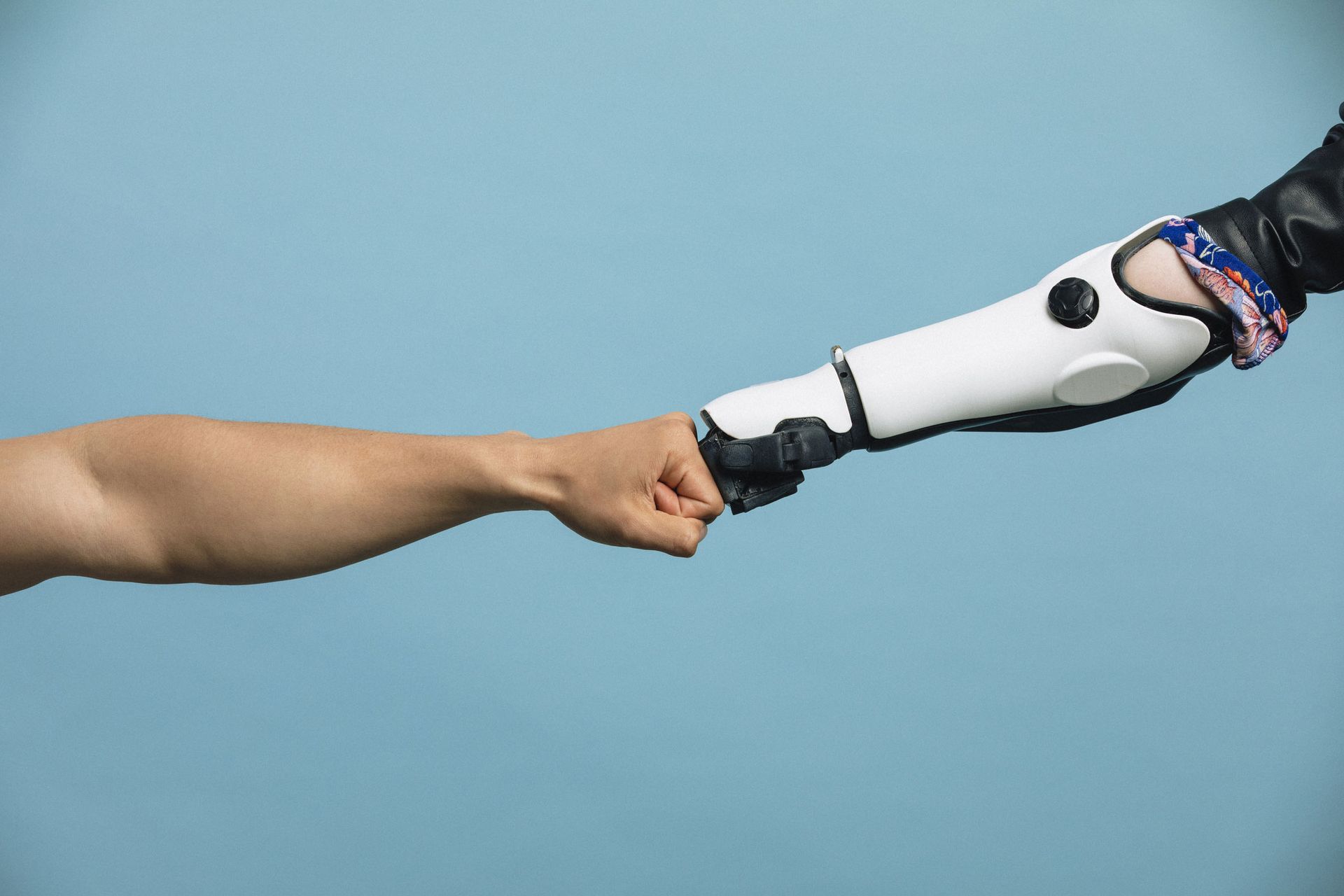 A Human And Robotic Arm Making A Fist Bump - Crystal River, FL - Kidder Orthopedic Laboratories