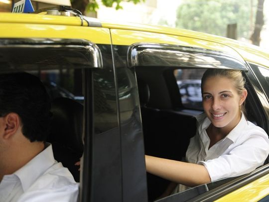 Happy Female passenger inside of a taxi