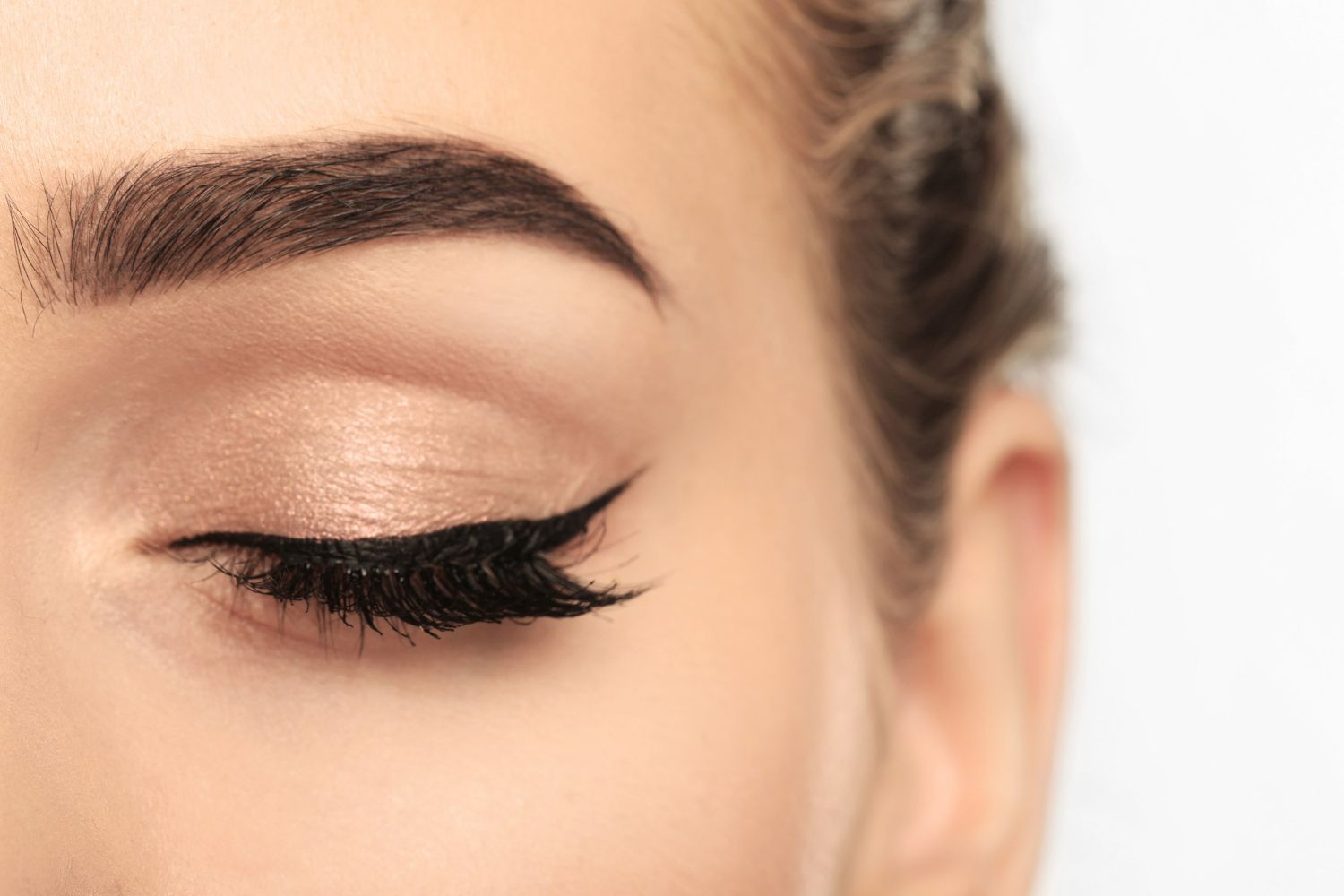 A close up of a woman 's eye with eyeliner on it.