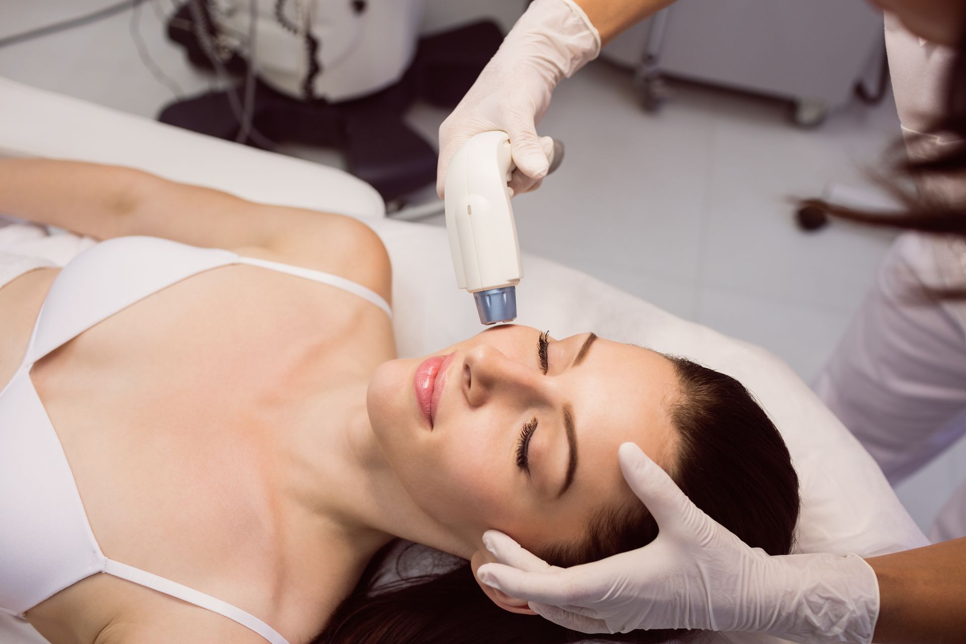 A woman is getting a facial treatment at a beauty salon.