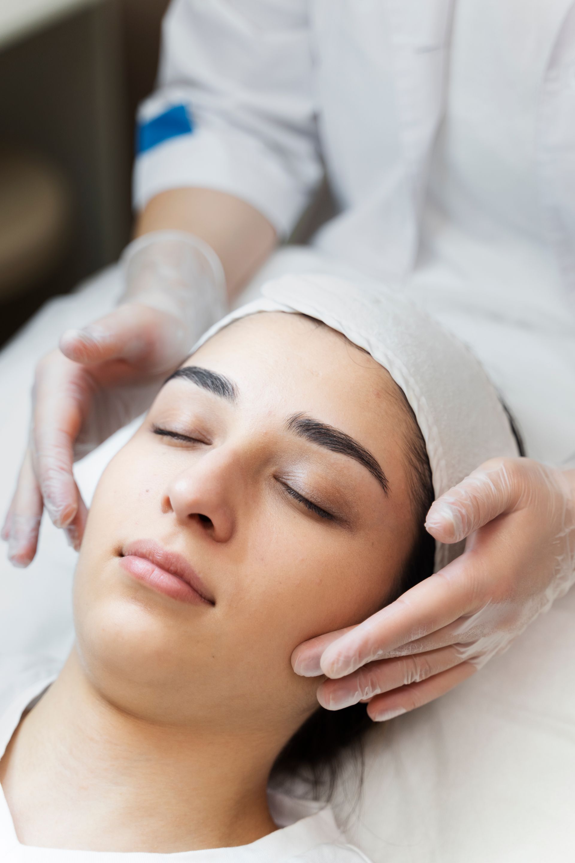 a woman is getting a facial treatment at a beauty salon .