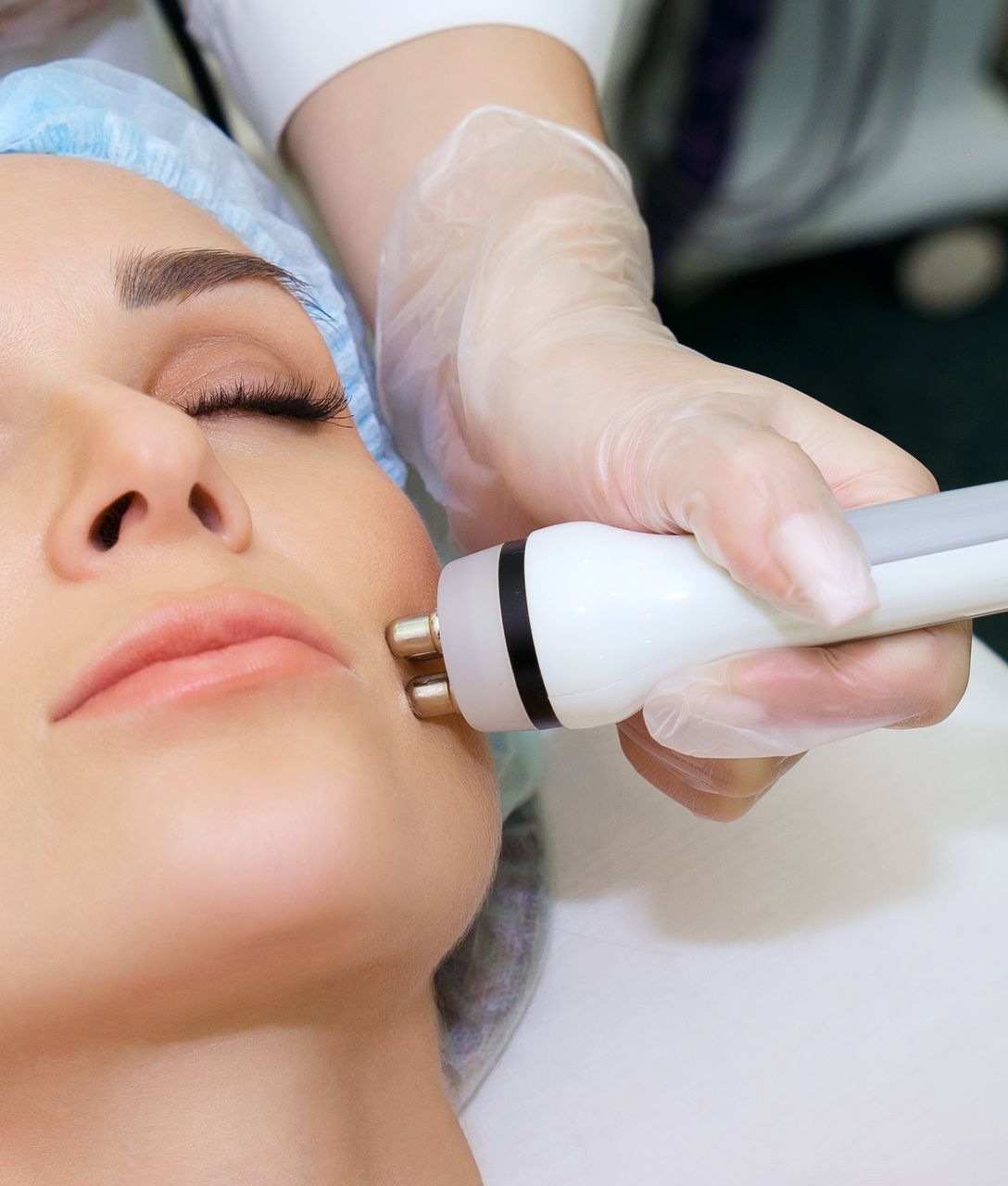 a woman is getting a facial treatment with a pen on her face .