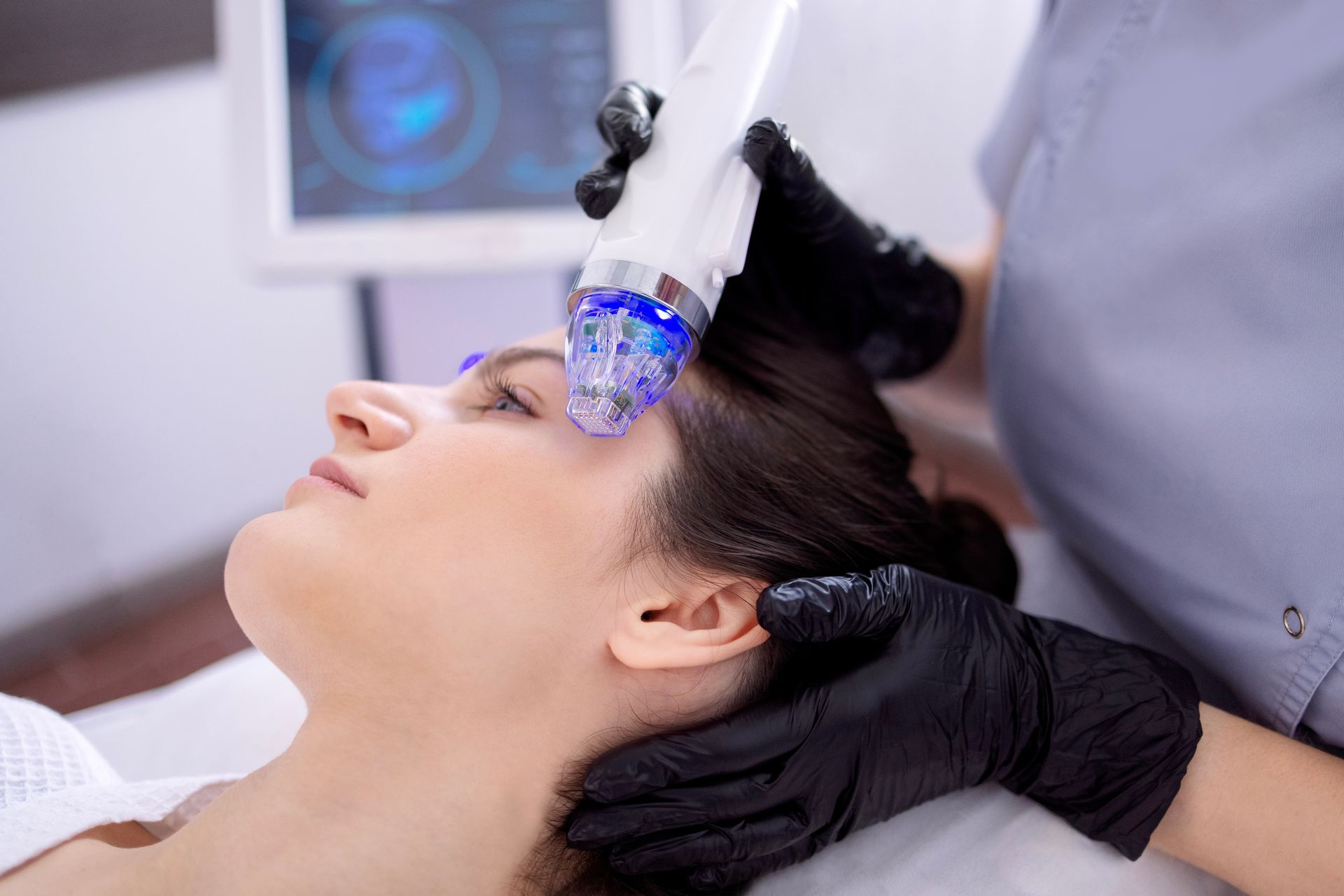 A woman is getting a facial treatment at a beauty salon.