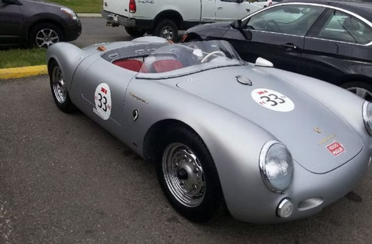 Silver vintage Porsche race car with number 33, parked in lot. | Acadia Auto Service