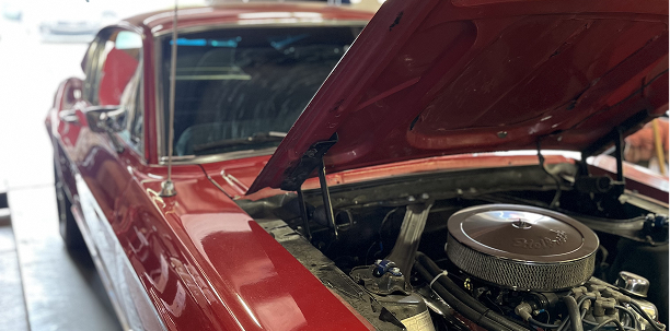 Red classic car with hood open, engine visible.  | Acadia Auto Service