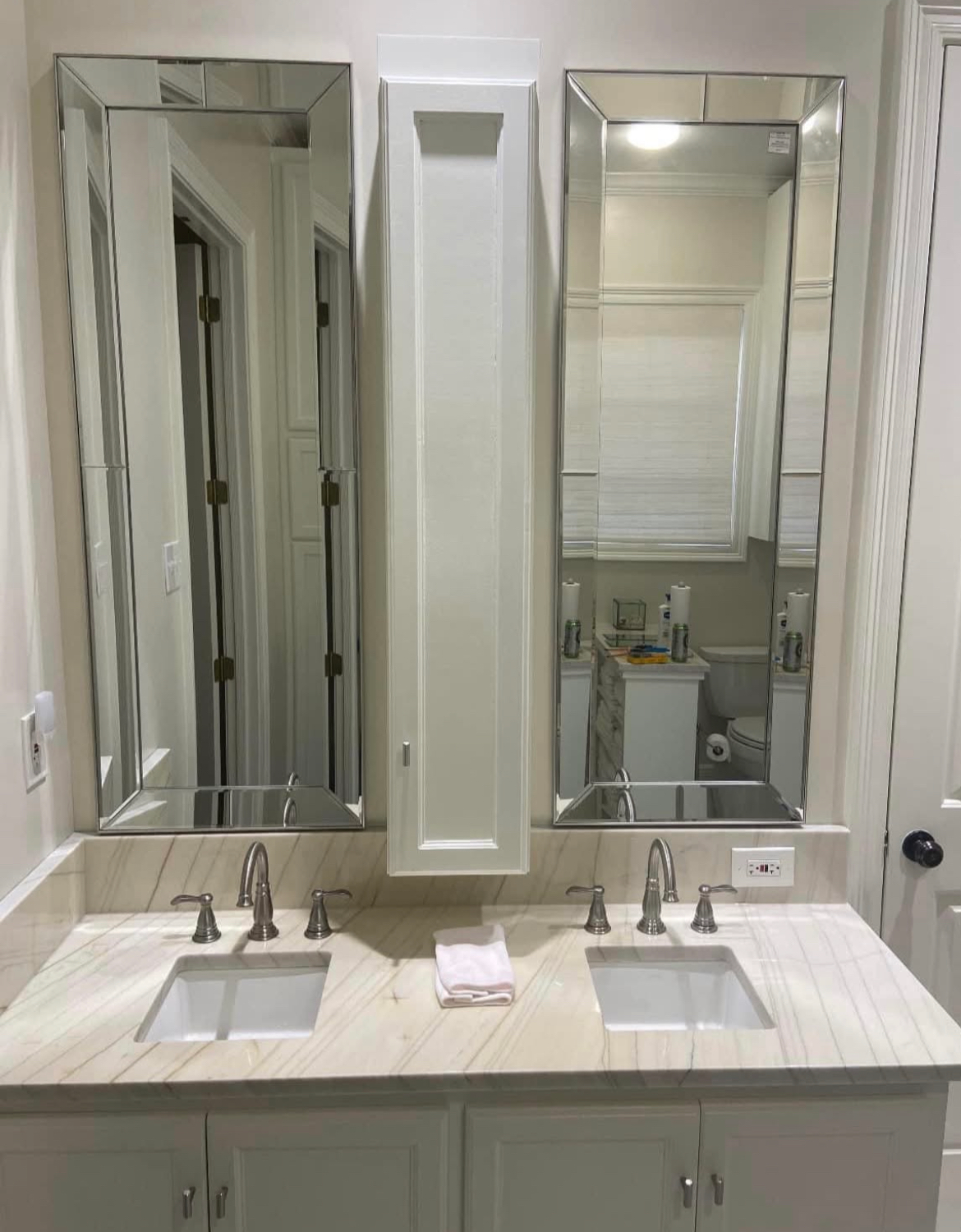 A bathroom with two sinks and two mirrors.