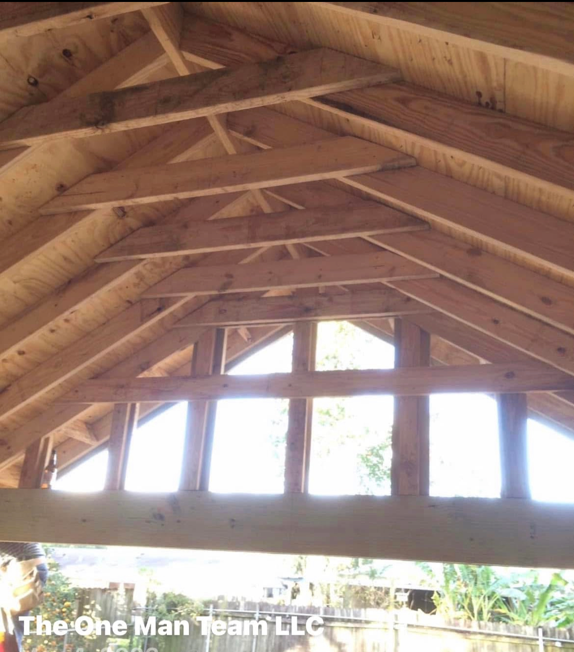 A picture of a wooden structure taken by the one man team llc
