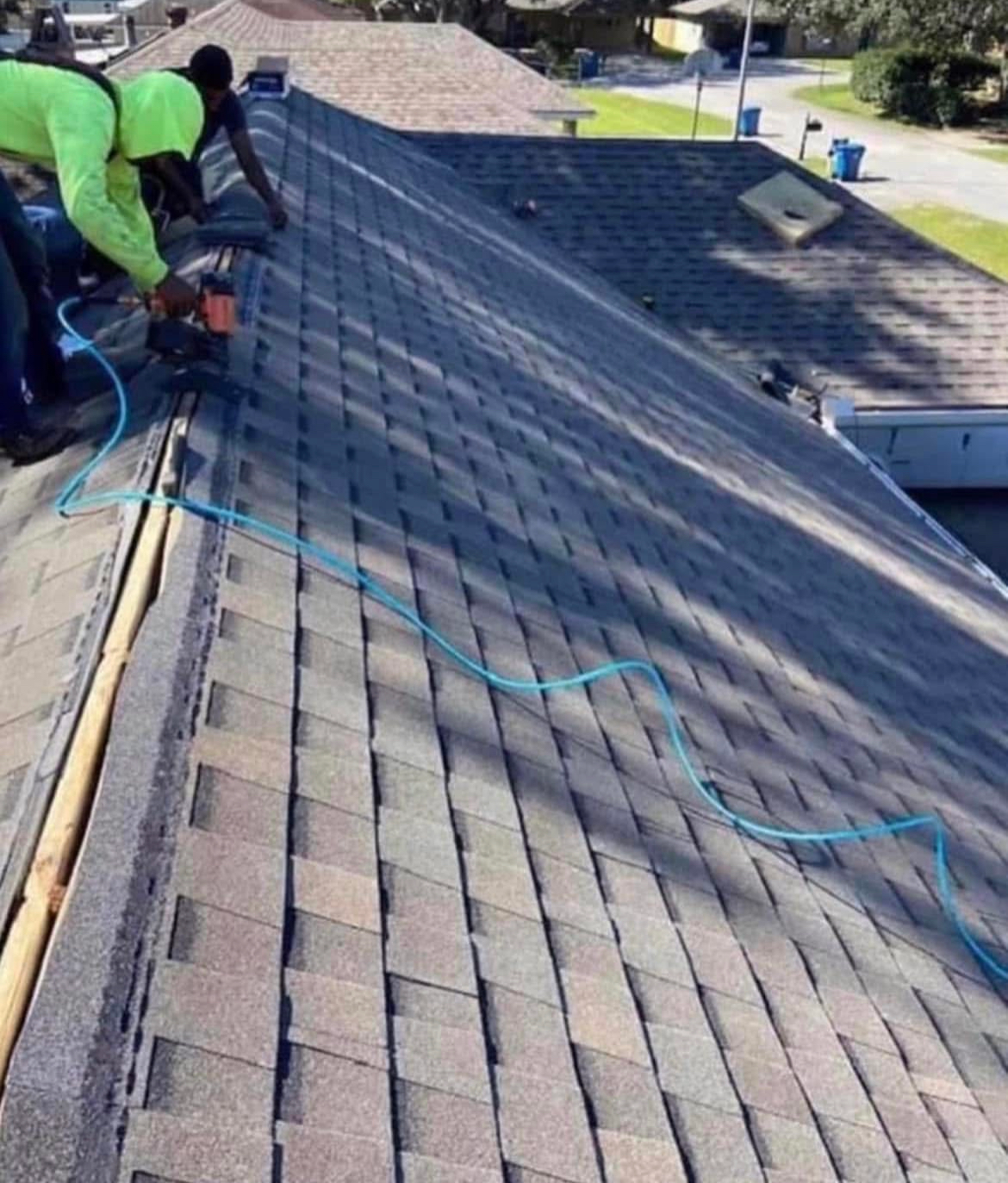 A man is working on the roof of a house.