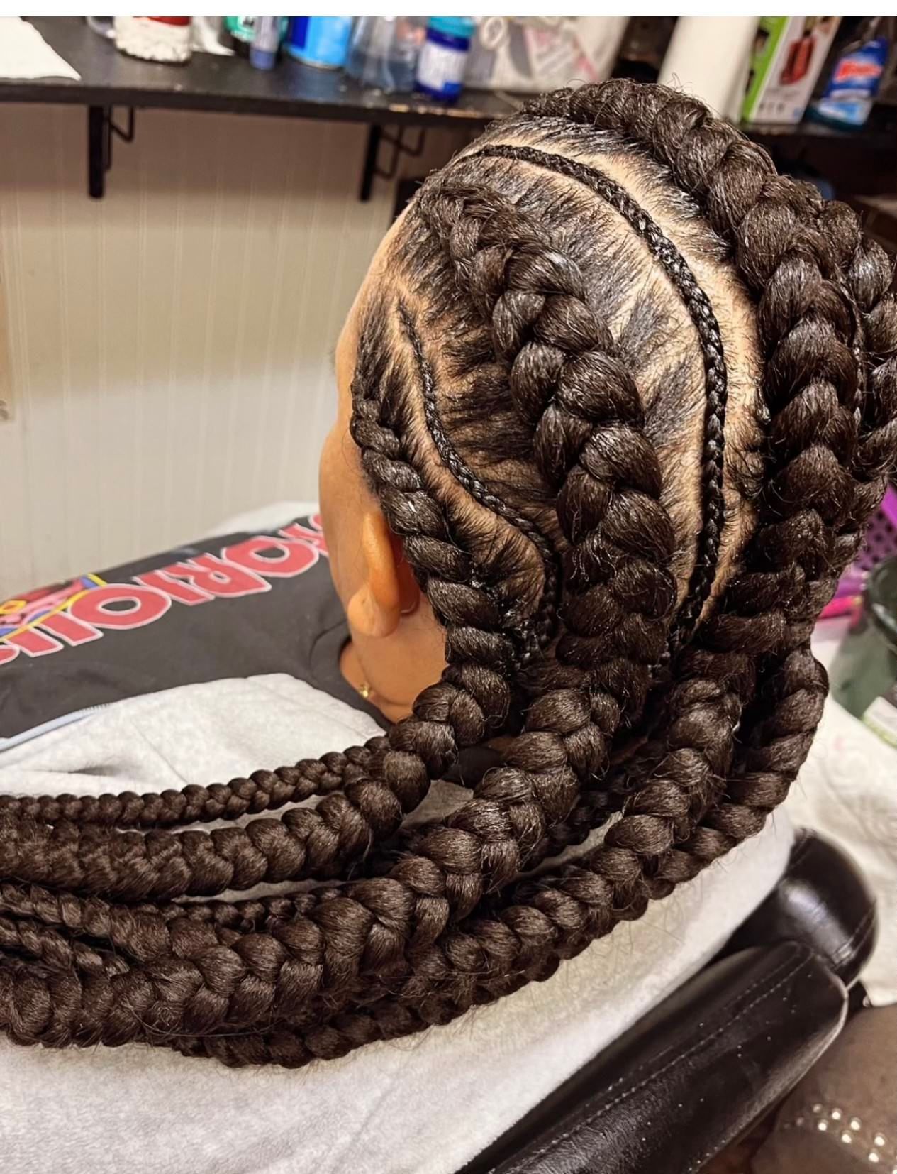 A woman with braids is wearing a shirt that says monopoly | Los Angeles, CA | Aissata & Al Diouma