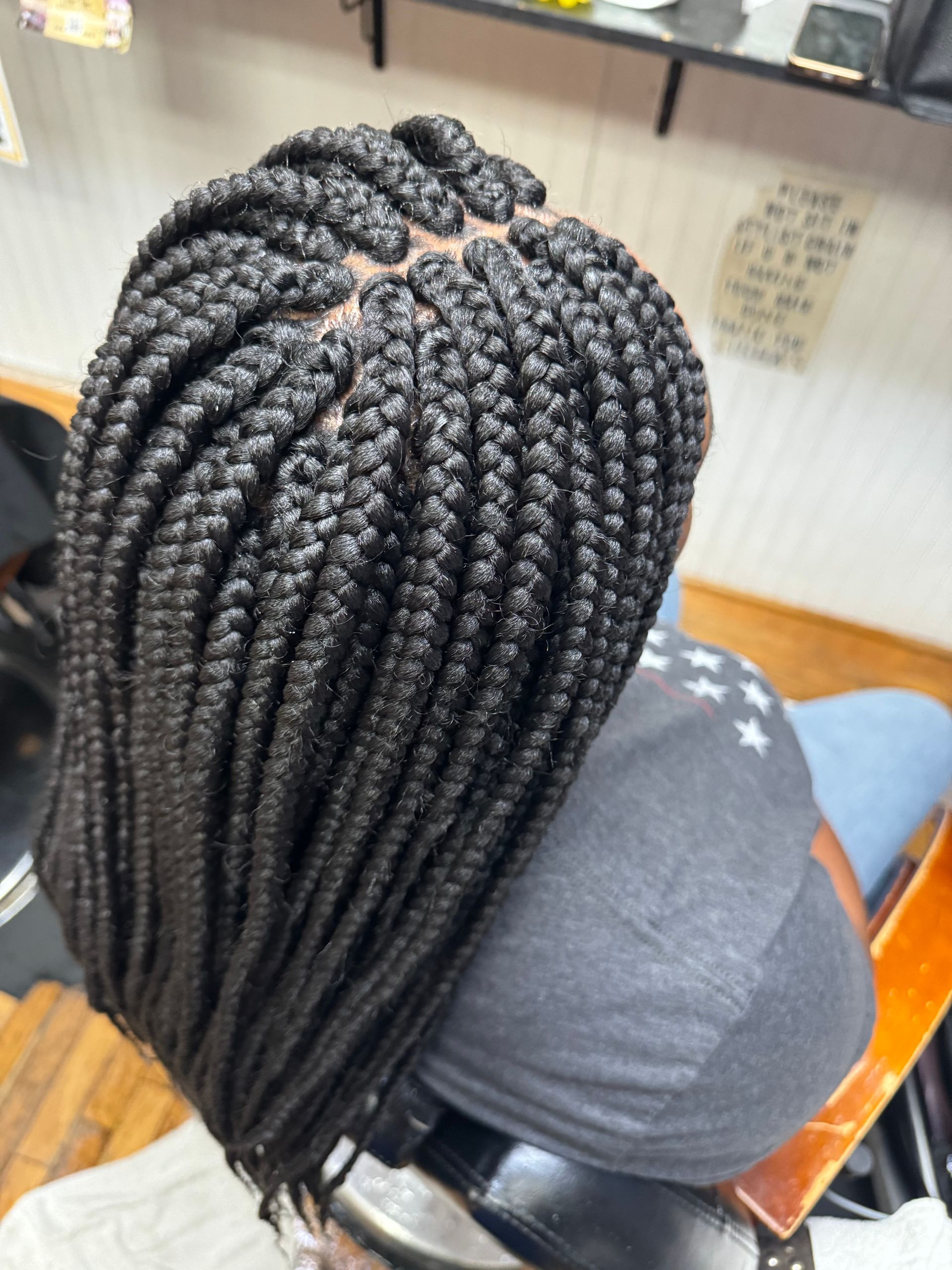 A woman with braids in her hair is sitting in a chair | Los Angeles, CA | Aissata & Al Diouma