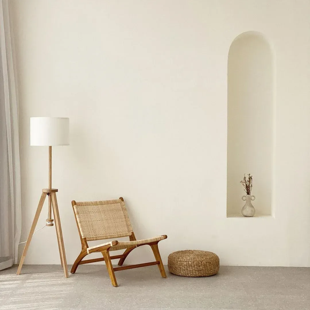 There is a chair and a lamp in the room.