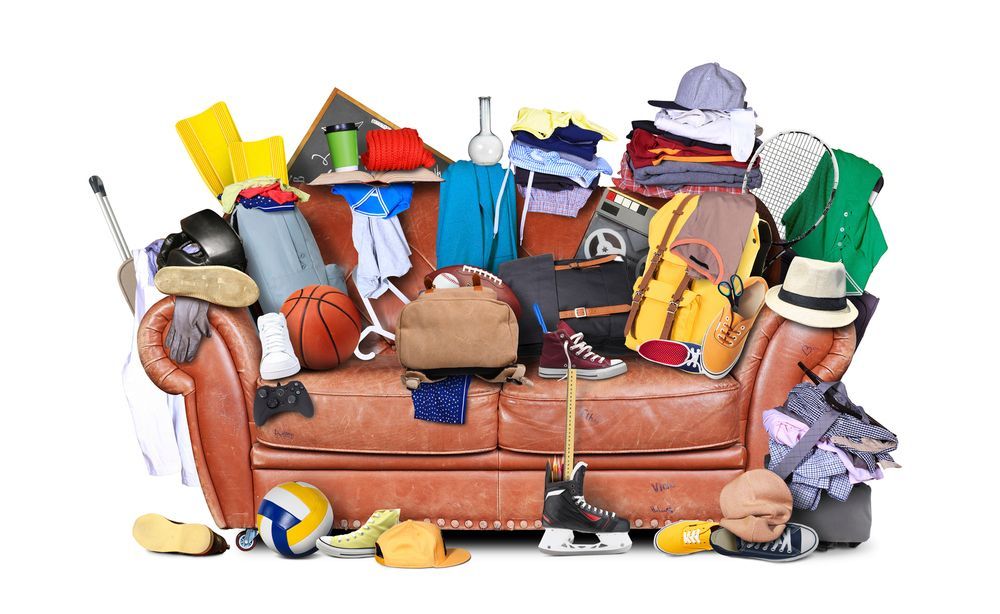 Animated image showing a couch piled high with junk and clutter, illustrating clutter removal services by Junk Haul-Stars.