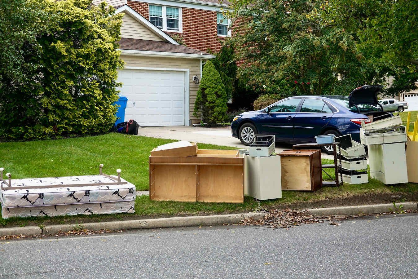 Pile of junk items in front of a Maryland home ready for hauling by Junk Haul-Stars professional junk removal services.