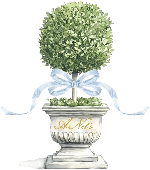 Topiary tree in a stone planter tied with a light blue ribbon, labeled