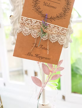Brown card with lace, lavender, and twine, reading 