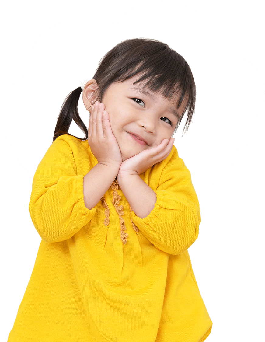 a little girl in a yellow sweater is smiling with her hands on her face .