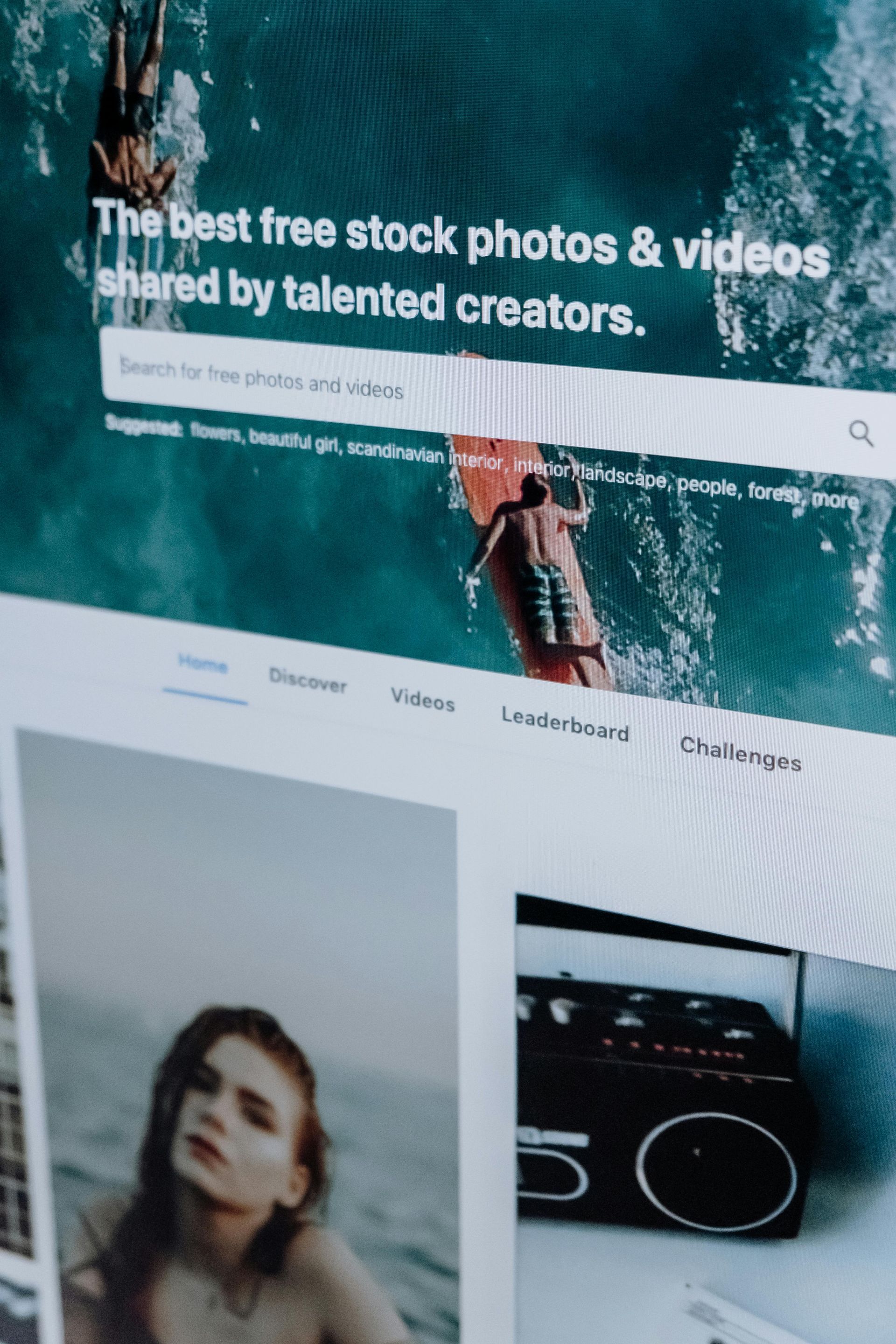 A close-up of a Pexels screen showing a search bar over a water background, with thumbnail images of a person and a radio.