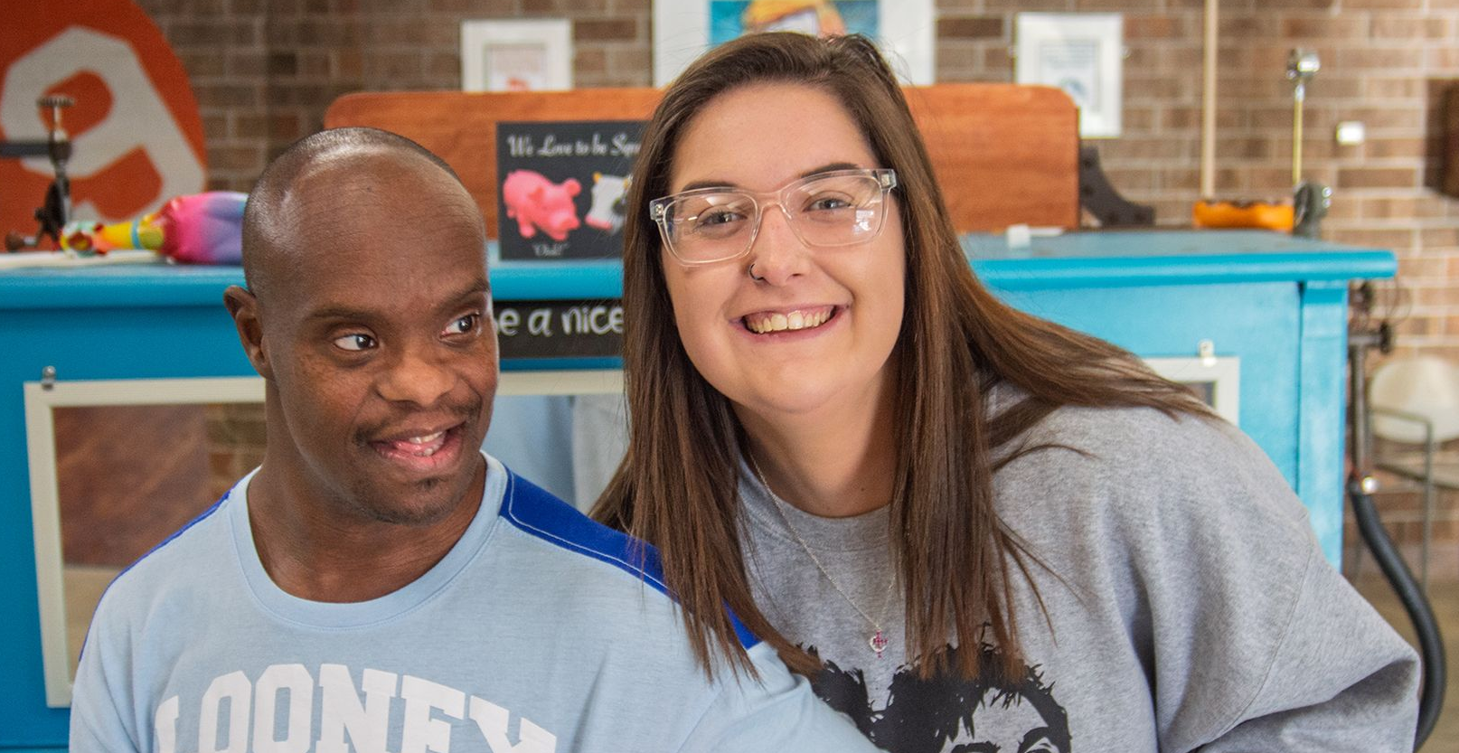 A DSP smiling with her arm around a man served by Orange Grove.