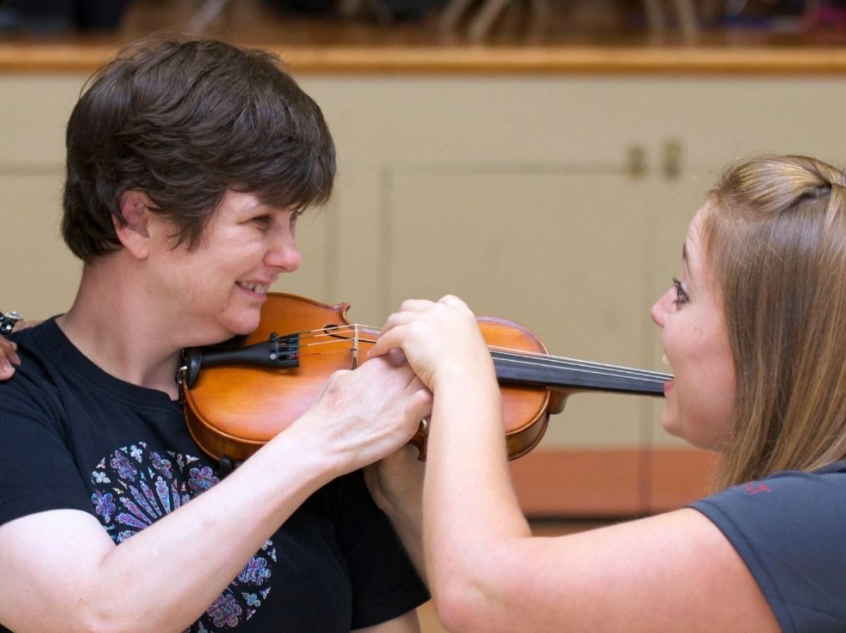 women teach violin