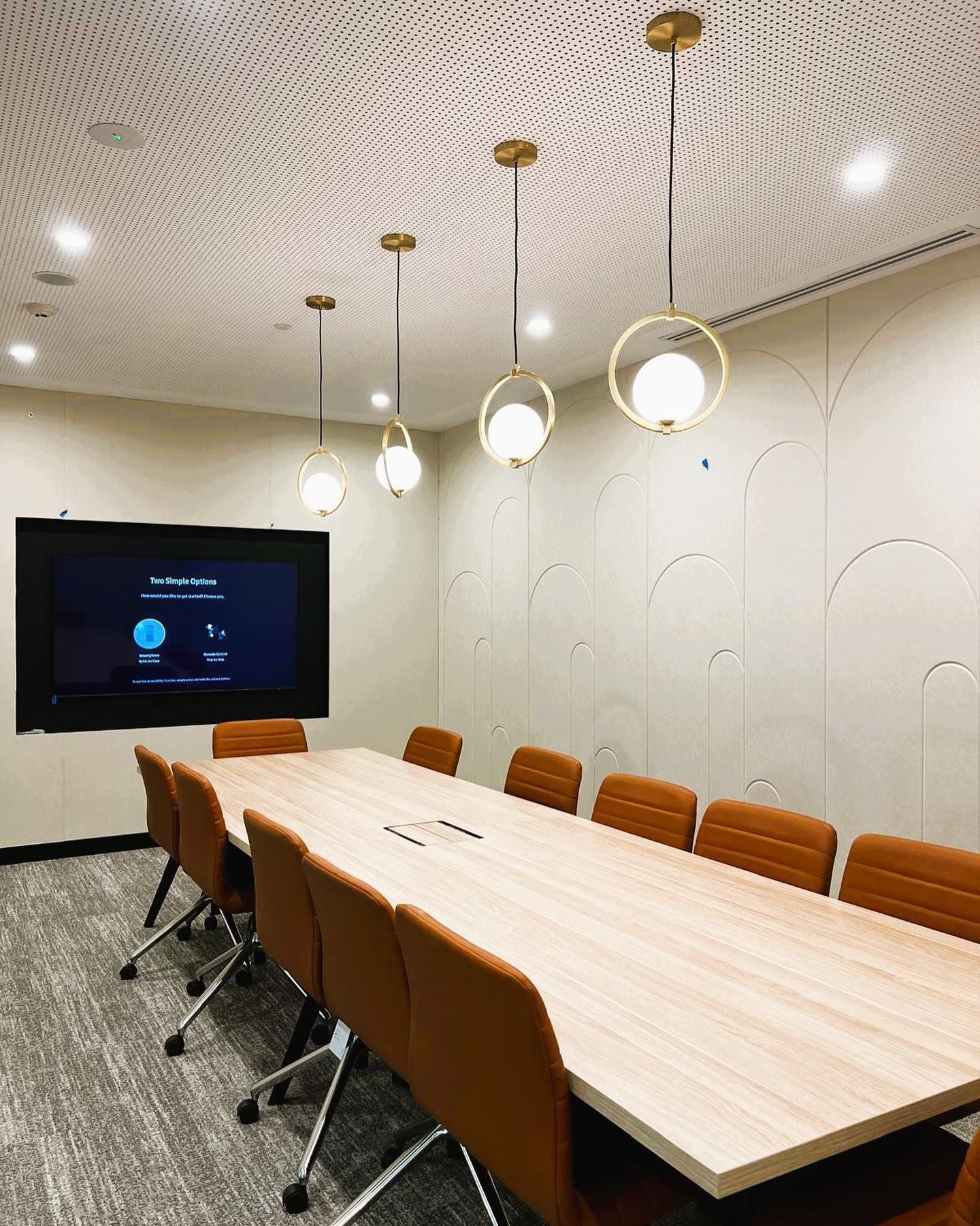 A man is installing solar panels on the roof of a building.
