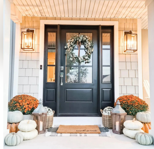 Front porch decorated for fall with pumpkins, mums, wreath, lanterns. Black door with sidelights. Windows & Doors | MasterCraft Roofing, Siding & Windows | Serving Eastern MA, NH & Selected Areas of VT