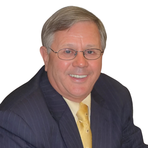 Man in glasses, suit, and tie smiling at the camera.