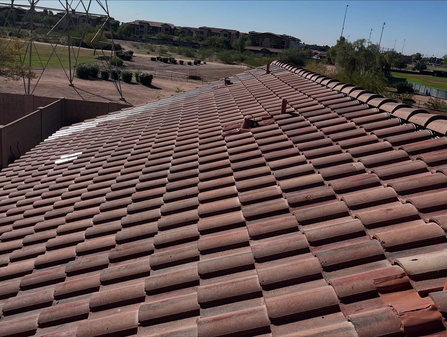 Red tile roof with a slight slope, outdoors on a sunny day.