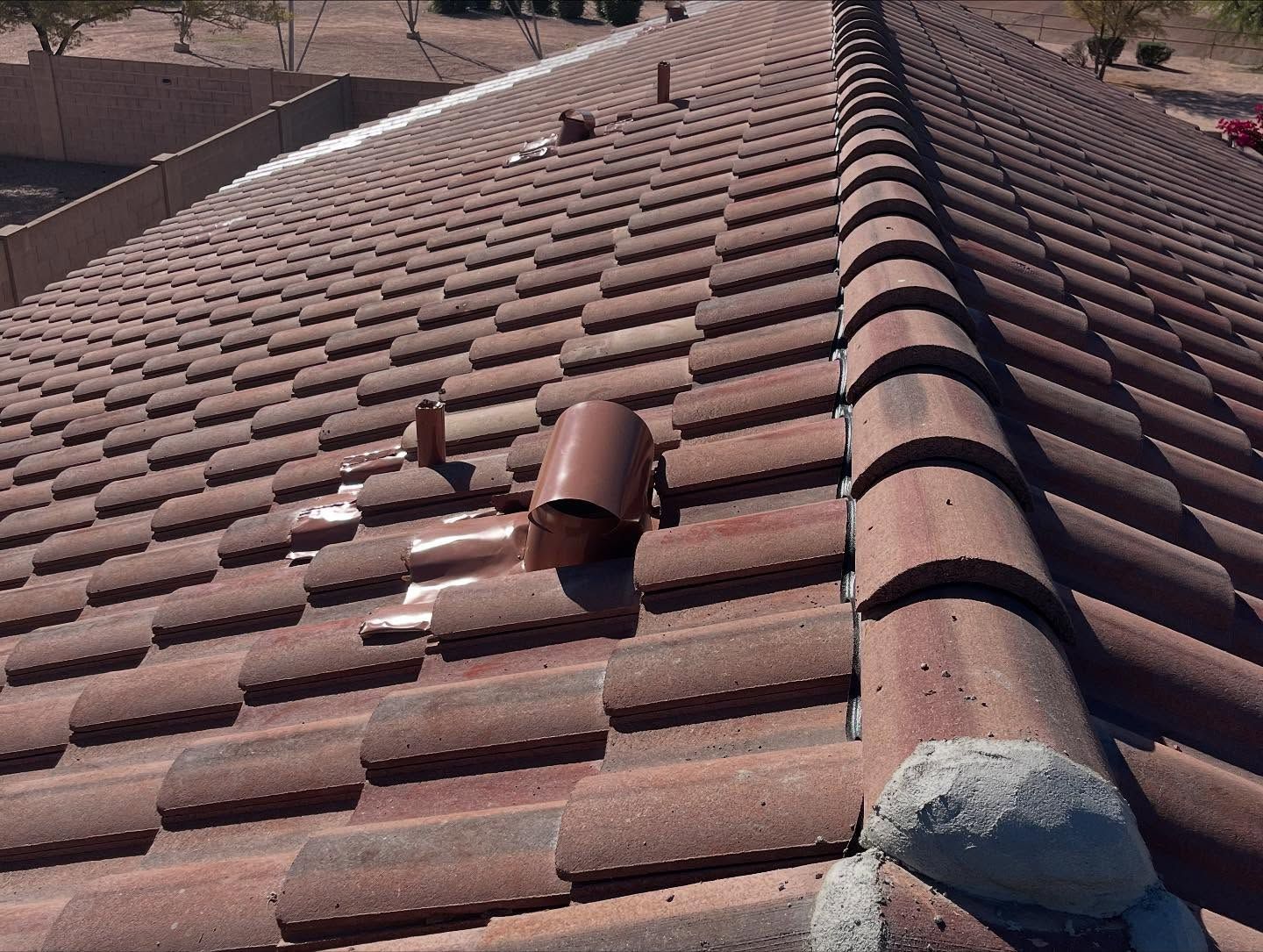 Red tiled roof with a broken vent.