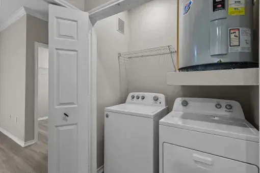 a laundry room with a washer and dryer and a refrigerator