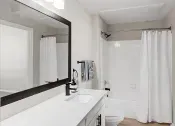 Thumbnail 6 of 27 - Renovated bathroom with White Cabinets