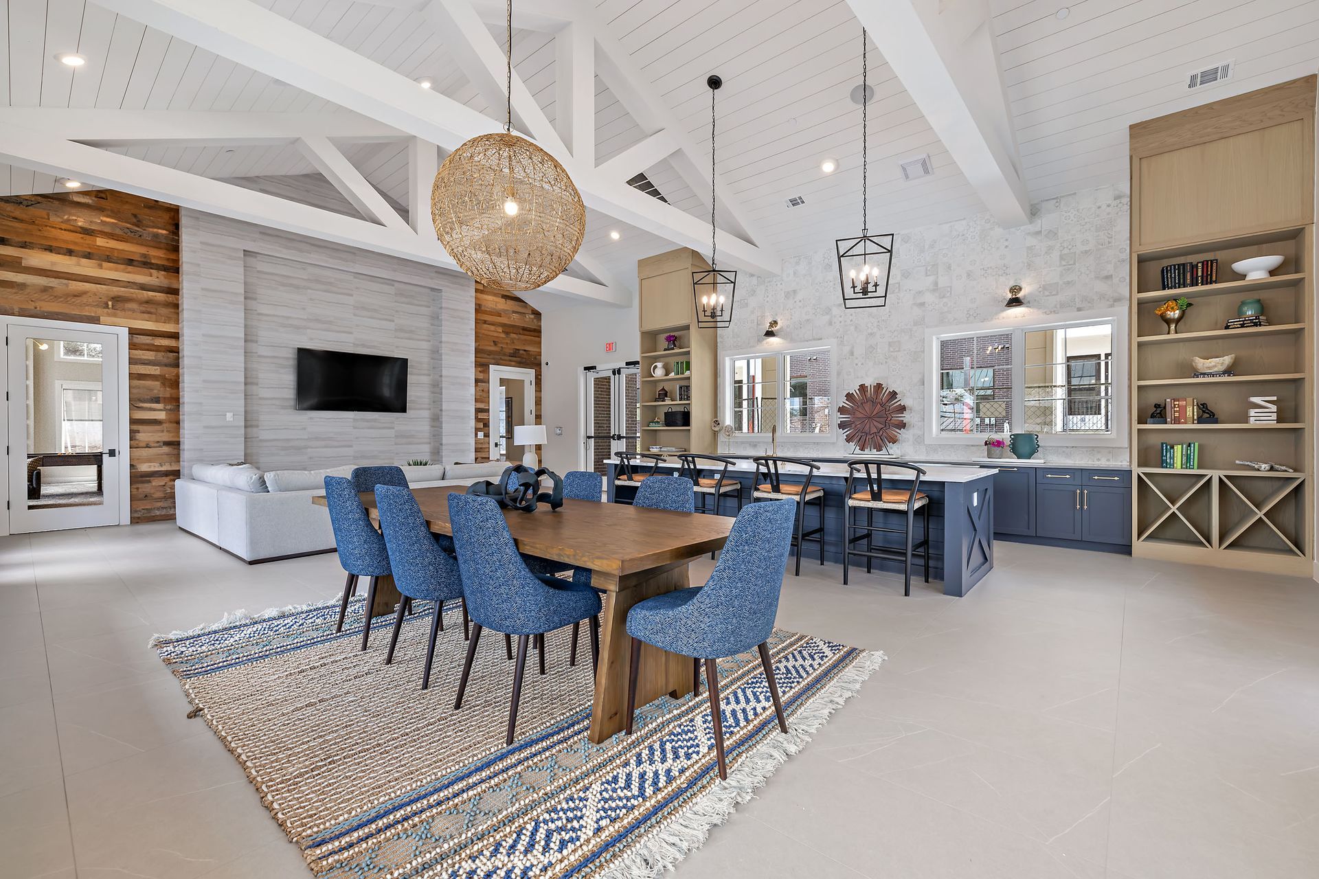 High ceiling clubhouse with a dining table and chairs in it at The Avery, offers apartments for rent in Brushy Creek Austin, TX.