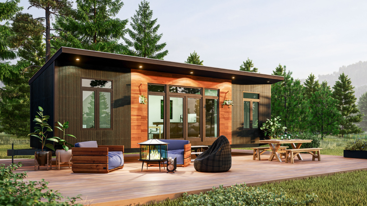 a small cabin with a patio in front of it surrounded by trees .