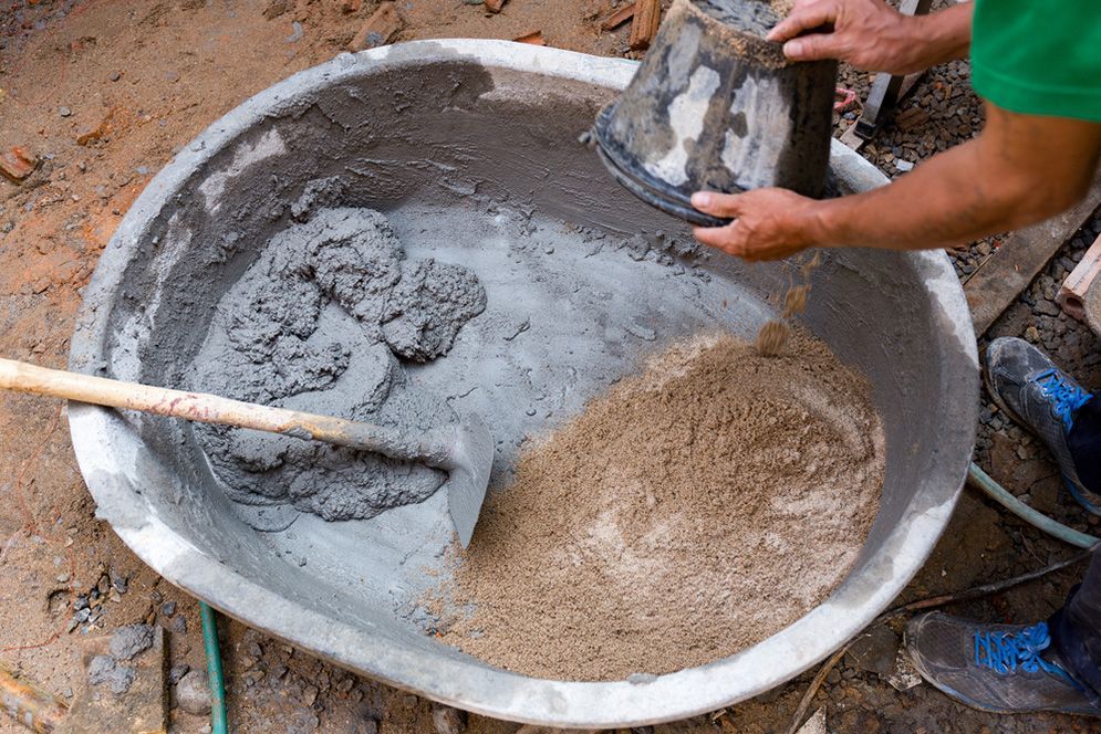 Mixing concrete in a tub with a shovel