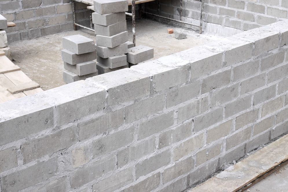 A Brick Wall is Being Built on a Construction Site — Small Batch Concrete Delivery in Tweed, NSW
