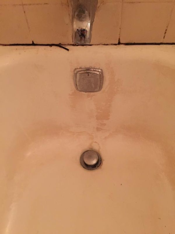 A close up of a bathroom sink with a faucet and drain.